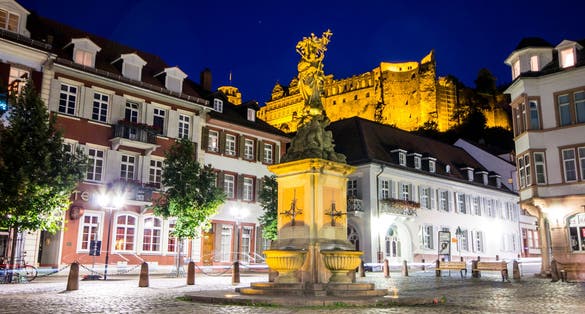 photo of view of Heidelberg, Germany. The Madonna statue in Kornmarkt square at nigh, Heidelberg, Germany.