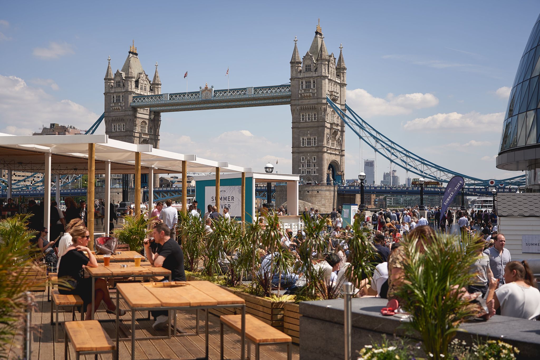 Outdoor dining and summer crowds near Tower Bridge in London..jpg