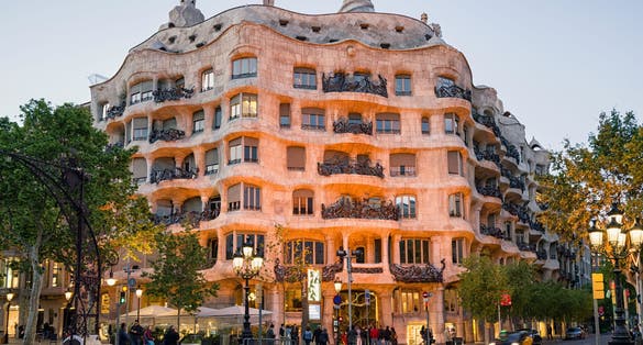 Photo of La Pedrera house designed by Antoni Gaudi at evening in Barcelona.