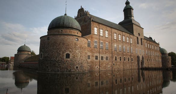 photo of Vadstena Castle with reflections in the moat in Vadstena, Sweden.