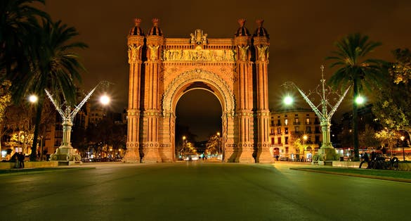 Photo of The Arc de Triomf, archway structure in Barcelona, Spain, at night.