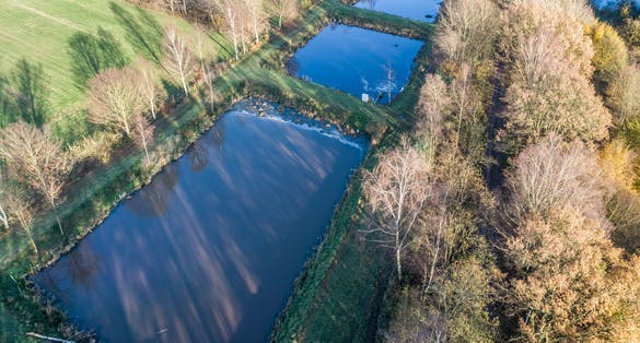 photo of view of Aerial view of a trout farm with three fish farms, near Wolfsburg, Germany, aerial view with drone