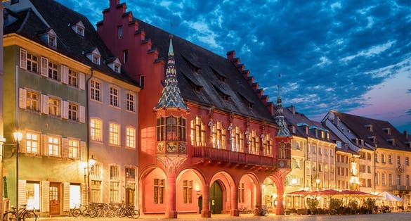 photo of historical building of Merchants Hall (Historisches Kaufhaus) built in 1520-21 and located on Munsterplatz squre in Freiburg, Baden-Wurttemberg, Germany.