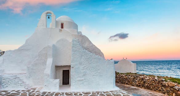 Photo of church of Panagia Paraportiani at sunrise, the most famous architectural structures in Greece, on the island Mykonos, The island of the winds, Greece.