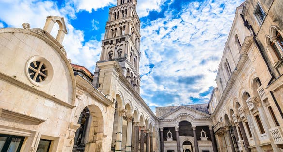 Photo of marble ancient roman architecture in city center of town Split, view at square Peristil in front of cathedral Saint Domnius and bell tower landmarks, Croatia.