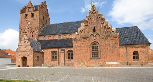 photo of view of Sankt Nikolaj Church is a red brick building in the town of Middelfart in Denmark.
