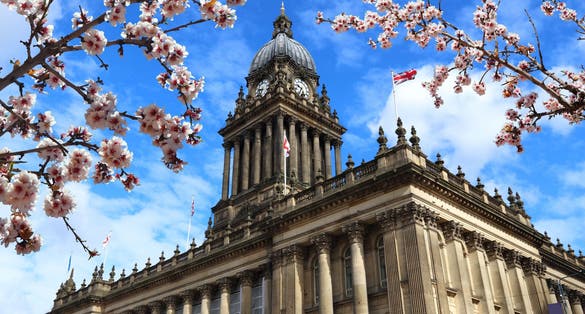 Photo of Leeds city, UK. City Hall building. Spring time cherry blossoms.