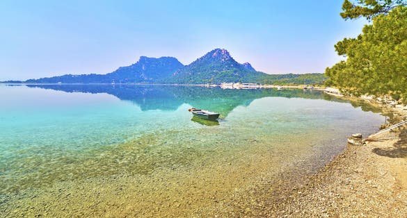 Photo of beautiful landscape of Heraion lake with small boat ,Vouliagmeni, Loutraki Greece.