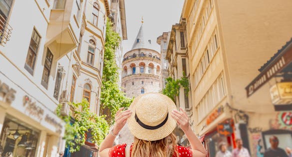 Photo of woman backside with view of Galata tower in Istanbul, Turkey.