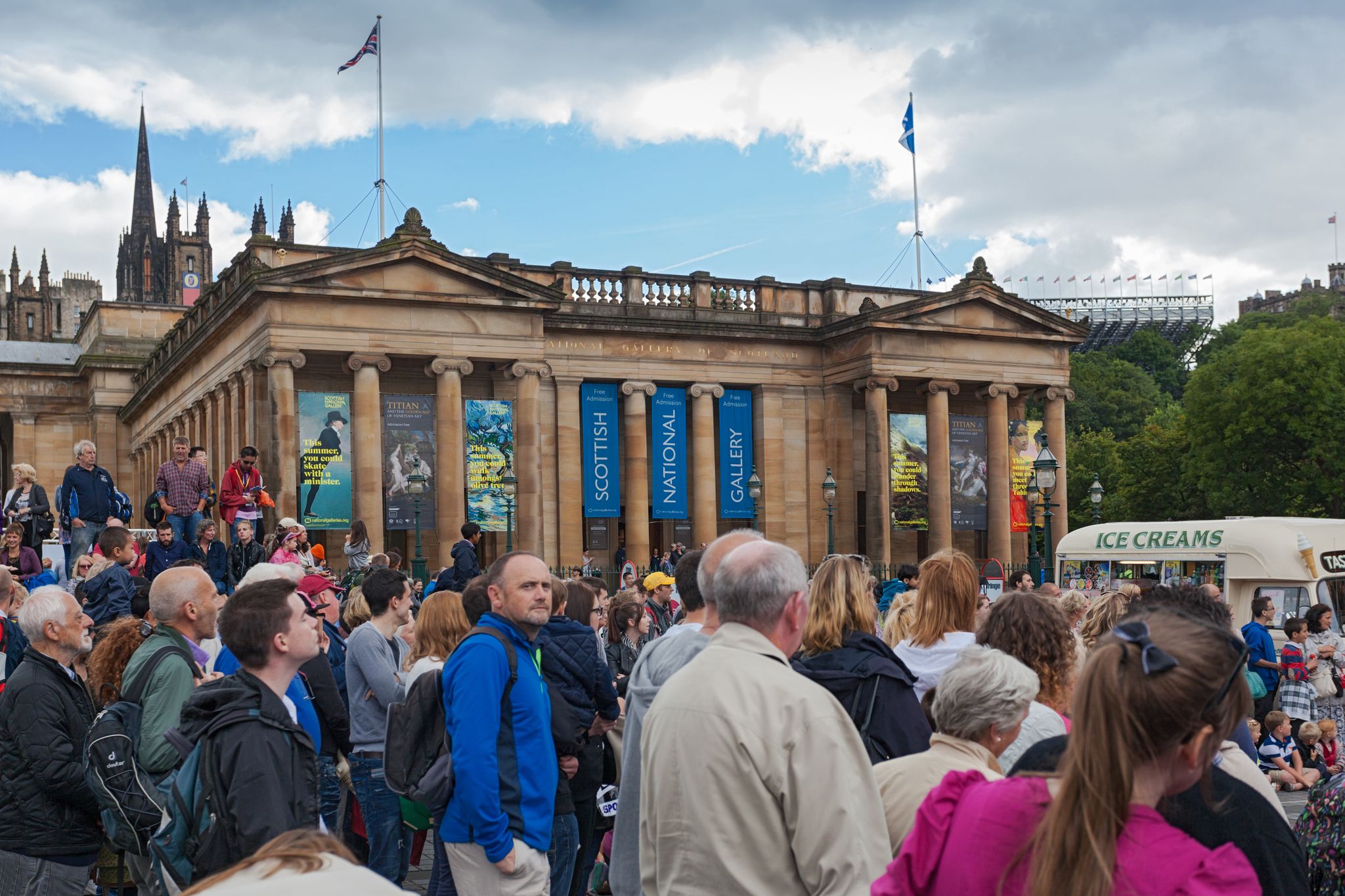 People in front of Scottish National Gallery. The gallery is housing the national collection of fine art.