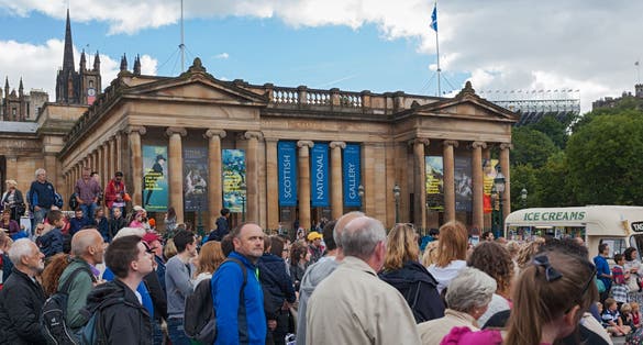 People in front of Scottish National Gallery. The gallery is housing the national collection of fine art.