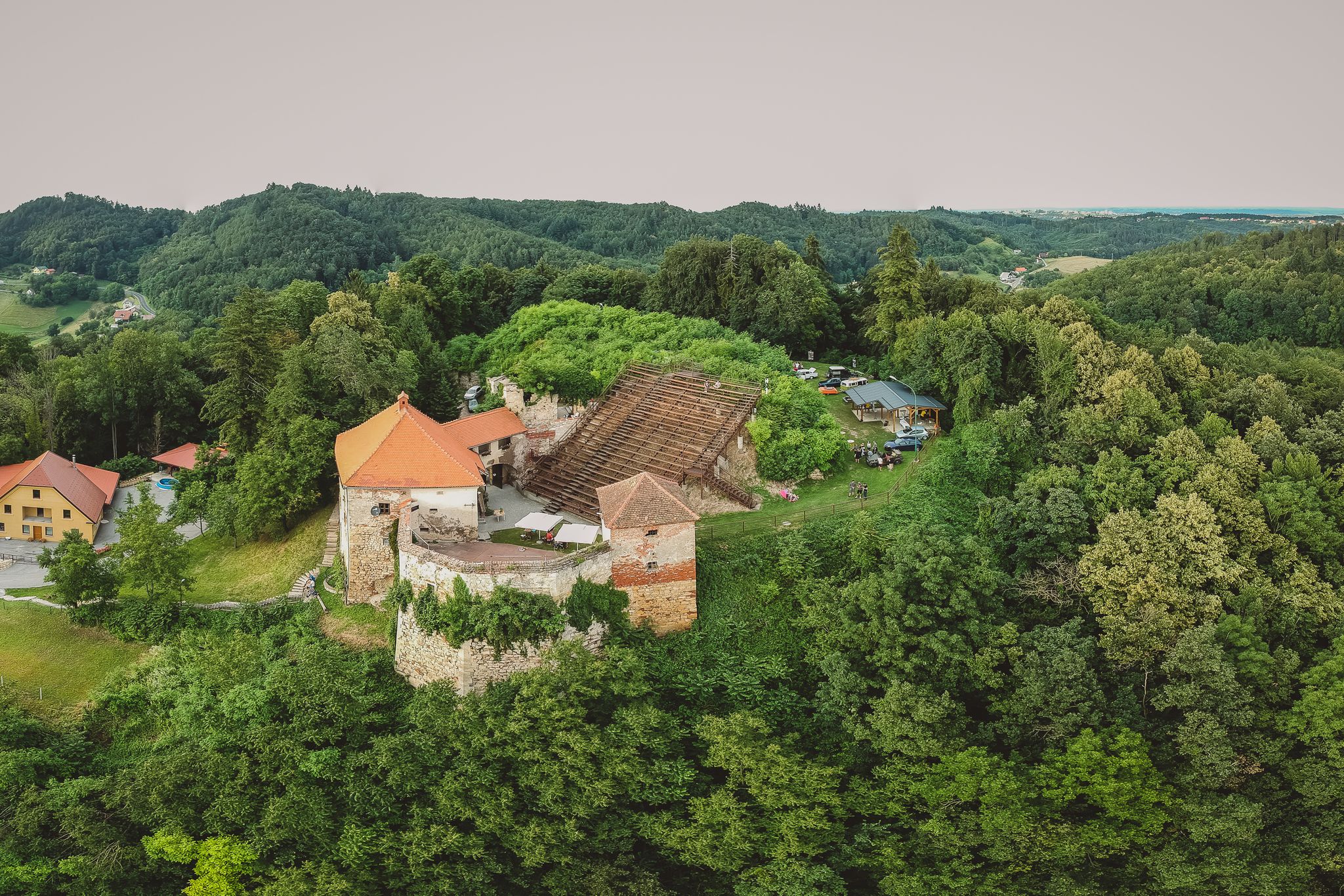 Photo of Drone panorama of a castle on a hill with a big staircase or an outdoor cinema or theatre. Outdoor theatre on a castle in Vurberg, Maribor, Slovenia.