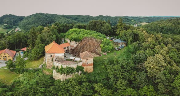 Photo of Drone panorama of a castle on a hill with a big staircase or an outdoor cinema or theatre. Outdoor theatre on a castle in Vurberg, Maribor, Slovenia.