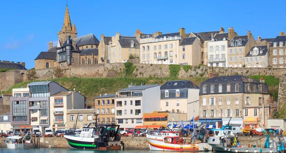 Gothic church on the hill and fishermen boats in port town Granville, Normandy, France