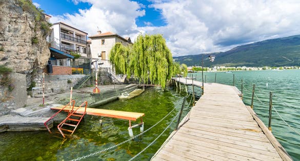 Photo of coastal scene with wooden walkway from Ohrid, North Macedonia.