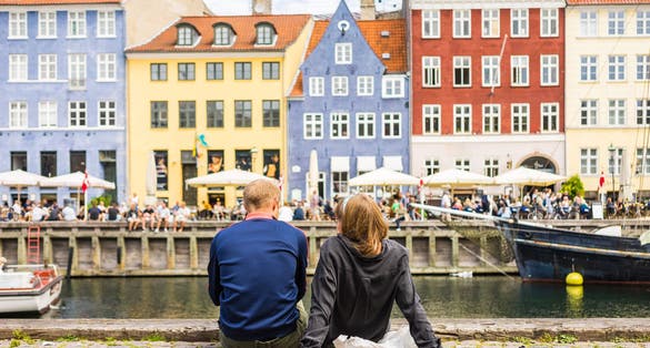 Photo of colorful building facades with boats and yachts in the Old Town of Copenhagen, Denmark