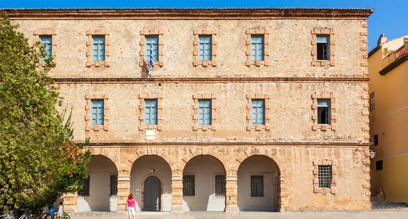 photo of view of Syntagma square, the historical square of Nafplio surrouned by old beautiful neoclassical buildings around the famous square, Greece.