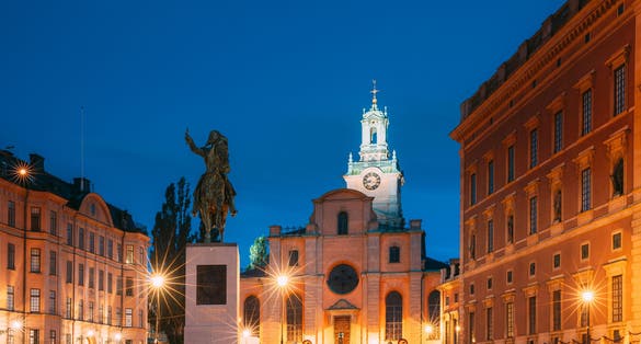 photo of Stockholm, Sweden. Statue of former Swedish King Karl XIV Johan Sitting on a horse near the great church Storkyrkan. Famous Popular Destination Scenic Place in night light.