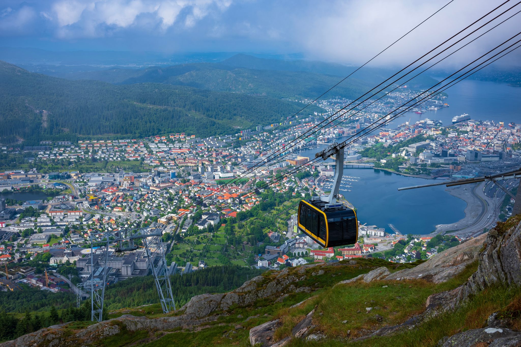 The view of Bergen, Norway, from Ulriken, the highest point of the Seven Mountains that surround the city, after a morning fog has lifted. The Ulriken Cable Car brings tourists to the peak.