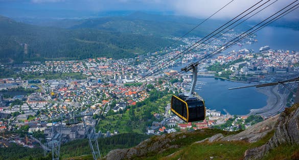 The view of Bergen, Norway, from Ulriken, the highest point of the Seven Mountains that surround the city, after a morning fog has lifted. The Ulriken Cable Car brings tourists to the peak.