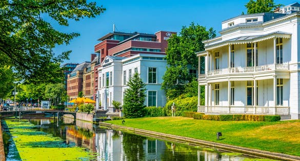 White mansion alongside a channel in the Hague, Netherlands