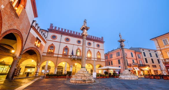 photo of view of Ravenna, Italy at Piazza del Popolo with the landmark Venetian columns at dusk.