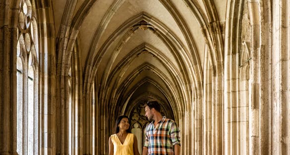 photo of couple men and woman walking by the church in Utrecht, Dom Church Utrecht, The Cathedral of Saint Martin Utrecht Dom Church Netherlands.