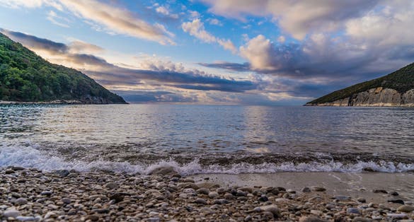 Photo of Valdanos beach at very beautiful sunset near Ulcinj, Montenegro. Beautiful bay with transparent water and breathtaking landscapes.