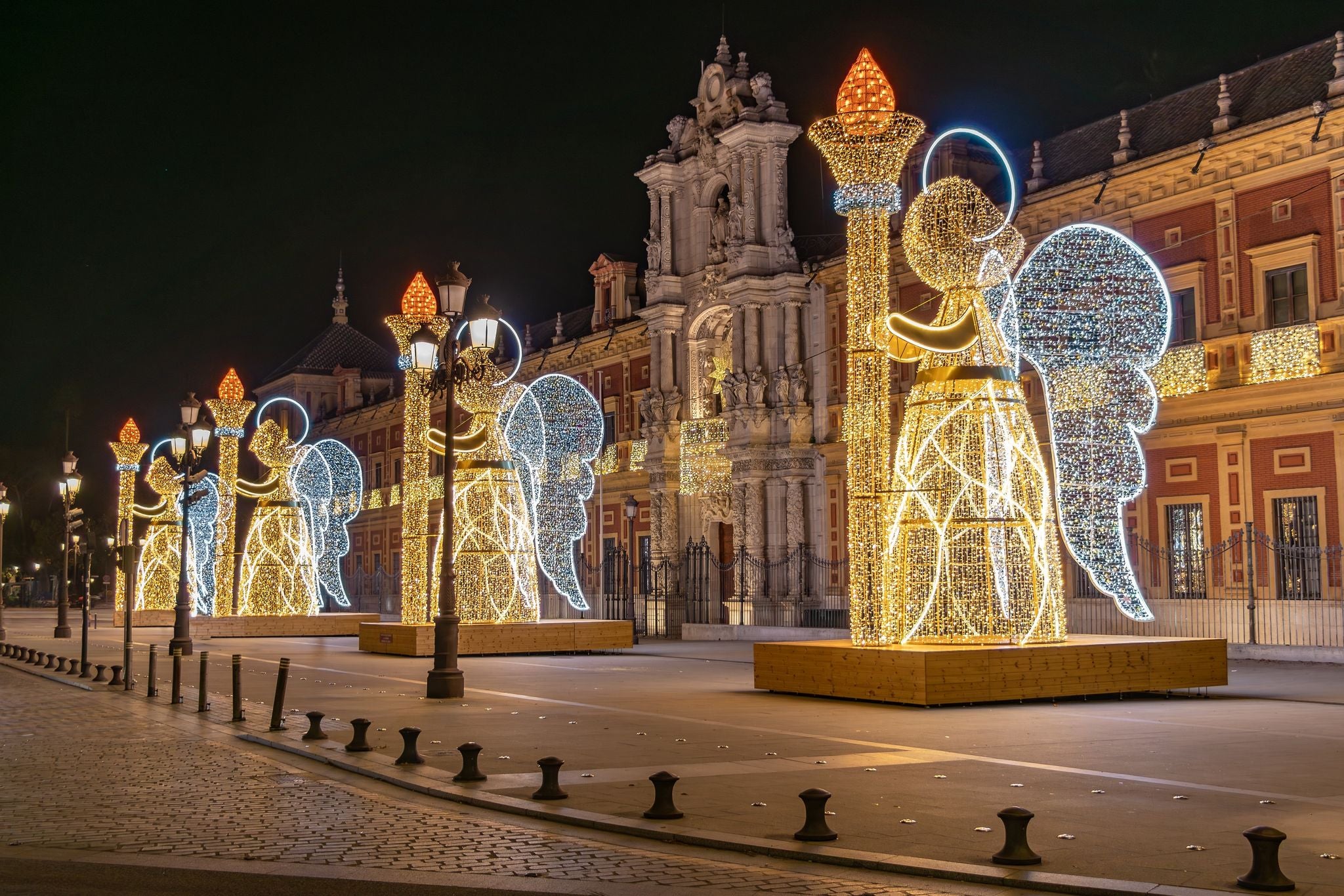 Christmas lights decoration in the shape of an angel holding a torch in from of The Palace of San Telmo, In Seville.jpg