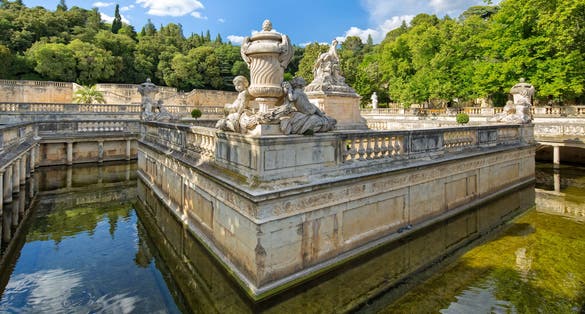 Photo of Le Nymphée with sculpture group at the park Les Jardin de la Fontaine in Nimes, France.