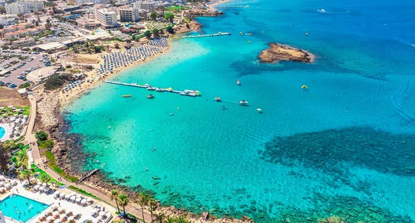Photo of aerial view of sandy beach and turquoise water of Fig tree bay beach, Protaras, Cyprus. 