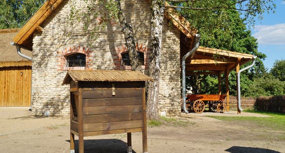 Bee hive and barn- Old wooden house for bees in retro style