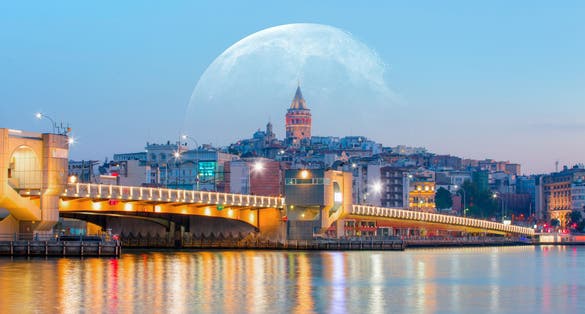 Galata Tower, Galata Bridge, Karakoy district and Golden Horn with full moon - istanbul, Turkey.