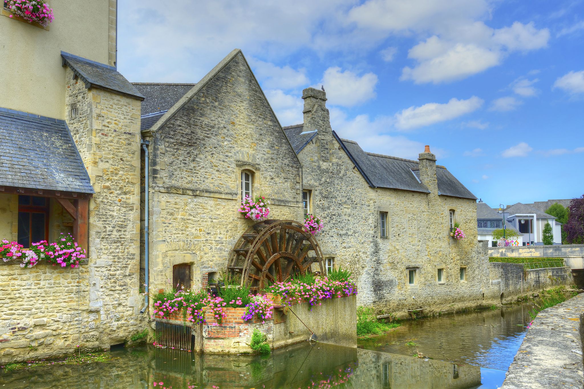 Photo of Old mill on river in the town of Bayeux, Normandy, France.