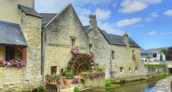 Photo of Old mill on river in the town of Bayeux, Normandy, France.