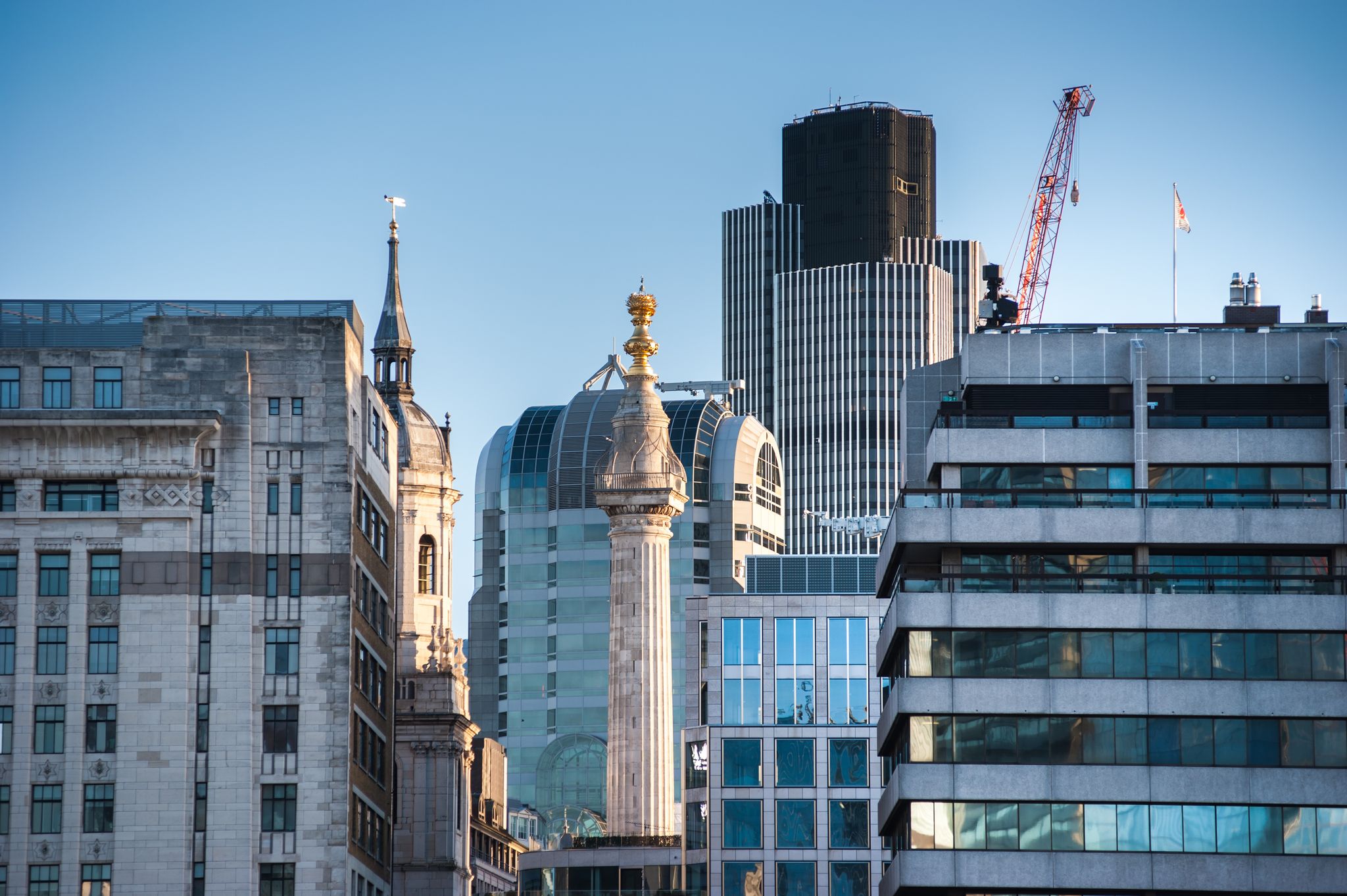 Photo of Monument tower in London shot from the southbank at sunrise on a beautiful sunny day, UK.