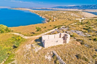 Vrsi bay and saint Lovre church ruin aerial view, stone desert of Zadar archipelago of Croatia