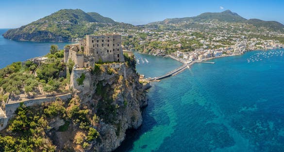 photo of Aerial view on Aragonese castle. The castle is the most impressive historical monument in Ischia, build in 474 BC. Aerial view of the island and town of Ischia.