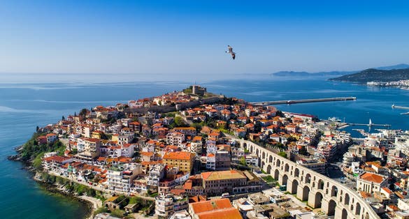 Photo of aerial view the city of Kavala in northern Greek, ancient aqueduct Kamares, homes and beaches.