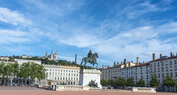 photo of the equestrian monument of King Louis XIV in Place Bellecour at morning in Lyon, France.