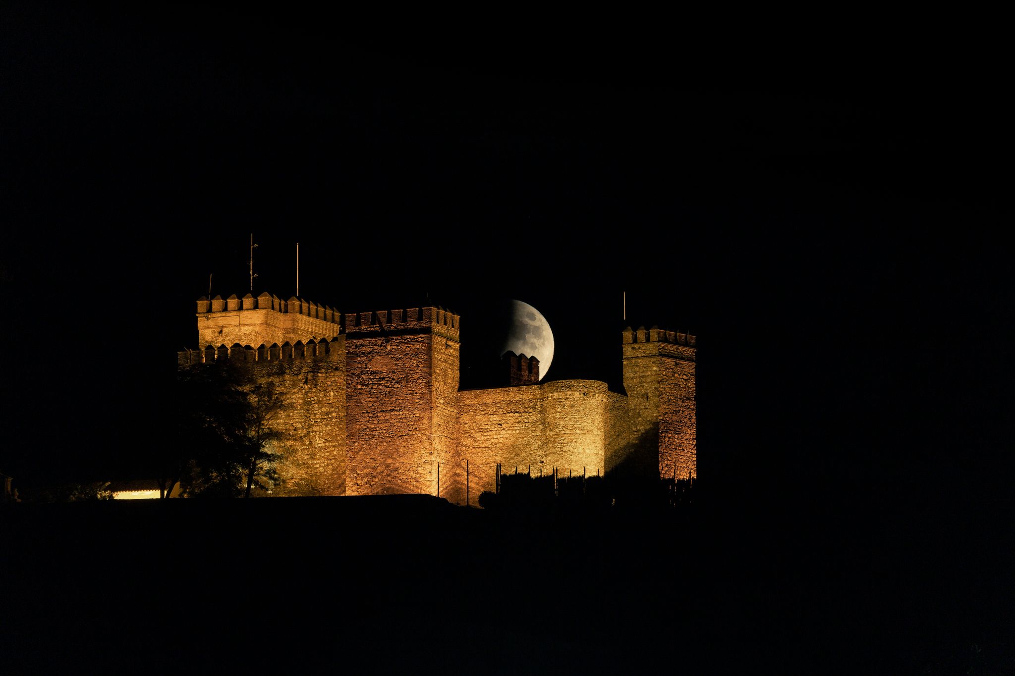 photo of night view of medieval Castillo de Cortegana in Huelva, Spain.
