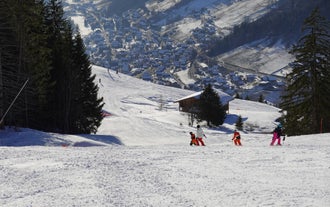 photo of Annecy city center panoramic aerial view with the old town, castle, Thiou river and mountains surrounding the lake, beautiful summer vacation tourism destination in France, Europe.