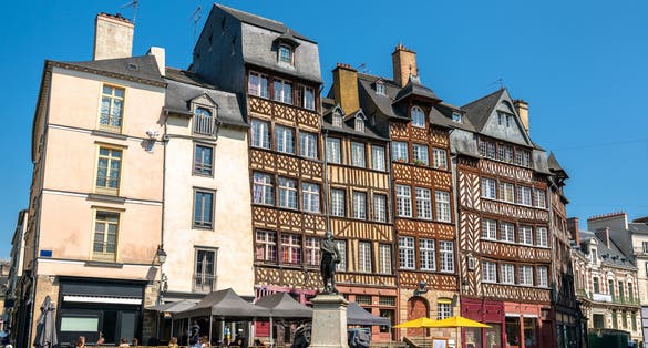 Photo of traditional half-timbered houses in the old town of Rennes, Brittany, France.