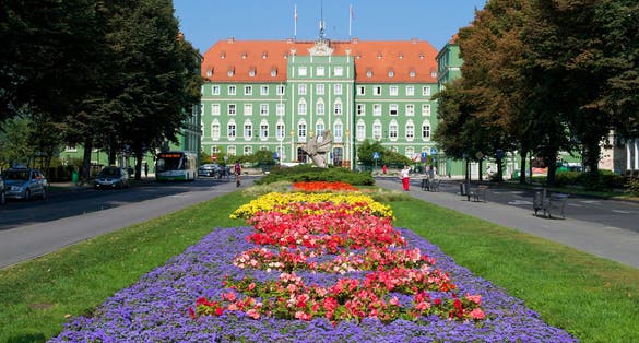 Photo of vibrant gardens leading up to the City Council of Szczecin.