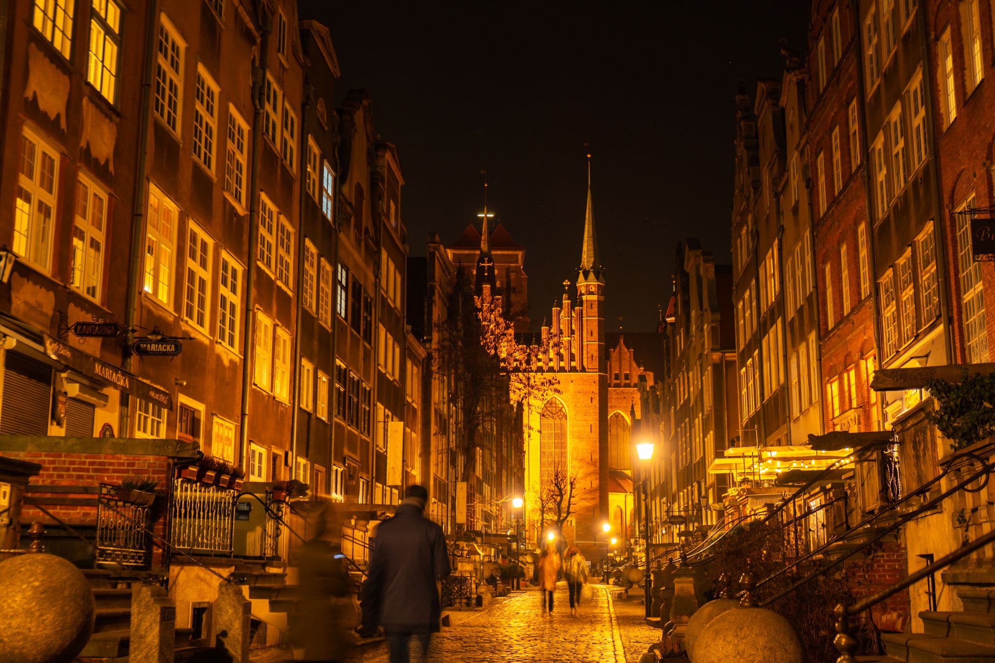 Cityscape of Gdansk with St. Mary Basilica and City Hall at night, Poland. Beautiful architecture of Mariacka street. St. Mary's church in the Old town center. Famous European street in Gdansk