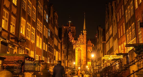 Cityscape of Gdansk with St. Mary Basilica and City Hall at night, Poland. Beautiful architecture of Mariacka street. St. Mary's church in the Old town center. Famous European street in Gdansk