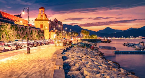Cathedral Basilica of Gaeta church on background. Dramatic summer sunset on the coast of Mediterranean sea, Italy, Europe. 