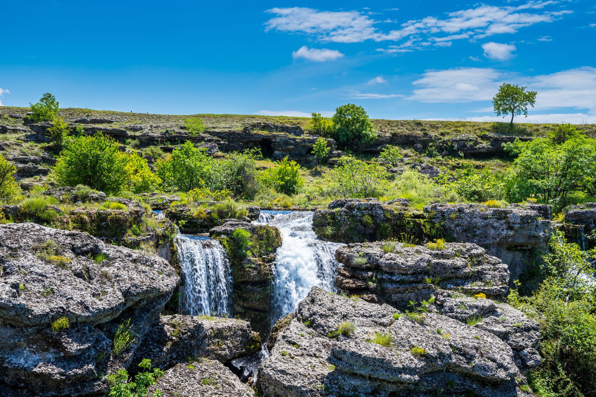 Photo of stunning waterfalls in rocky green scenery at Niagara falls landmark in Podgorica city, Montenegro.