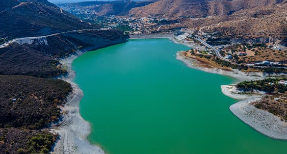 Photo of aerial view of Kouris Dam the water reservoir at the mountains, Cyprus.