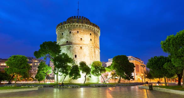 Photo of White tower at night in Thessaloniki, Greece.